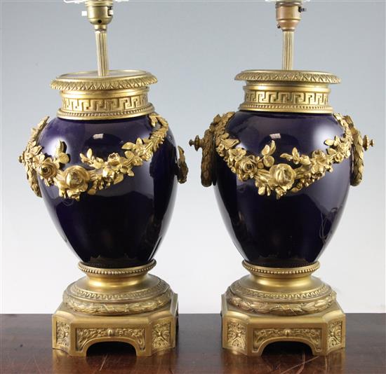 A pair of Louis XVI style ormolu mounted blue pottery table lamps, 17.5in.